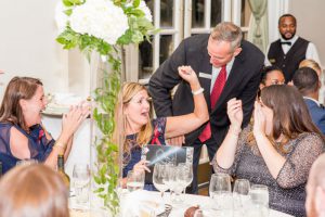 A guest celebrates after winning a live auction game.