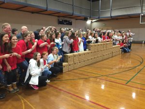 The ADPi sister pose with the packed meals.