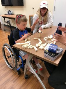 Trenton plays games with a volunteer group.
