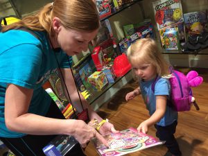 Abigail Mussi picks out a toy after achieving a medical milestone.