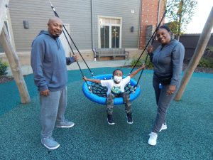 L-R: Chris, Christian and Vanessa enjoy swinging on the playground.