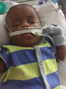 Emanuel Jr. naps in a blue and green striped onesie. (Courtesy: Stephens Family)