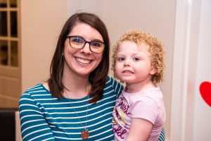 Mom and daughter smile for the camera