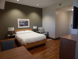 Guest room view showing bed, tv and table.